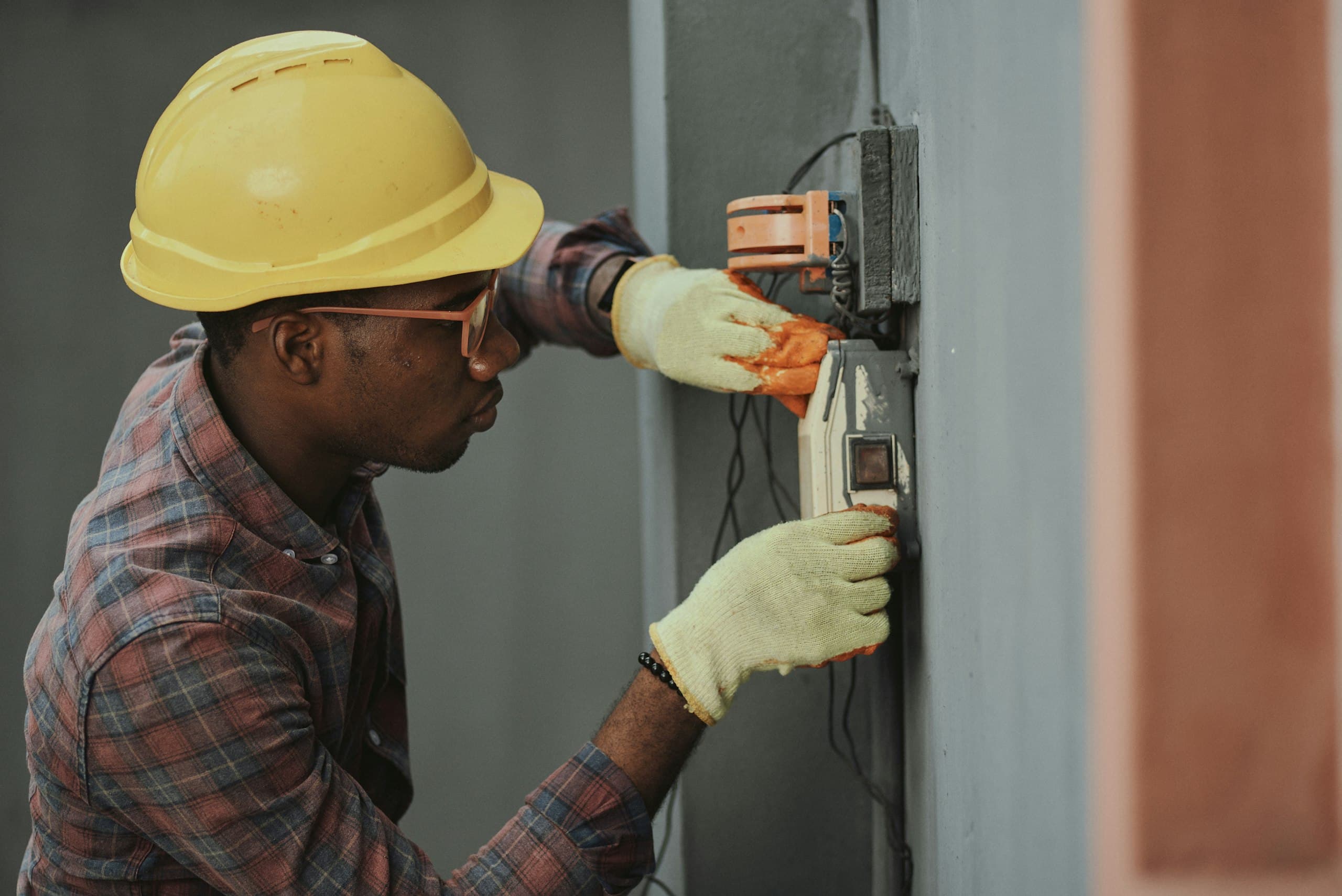 Inspector checking an exterior electrical meter and service connection