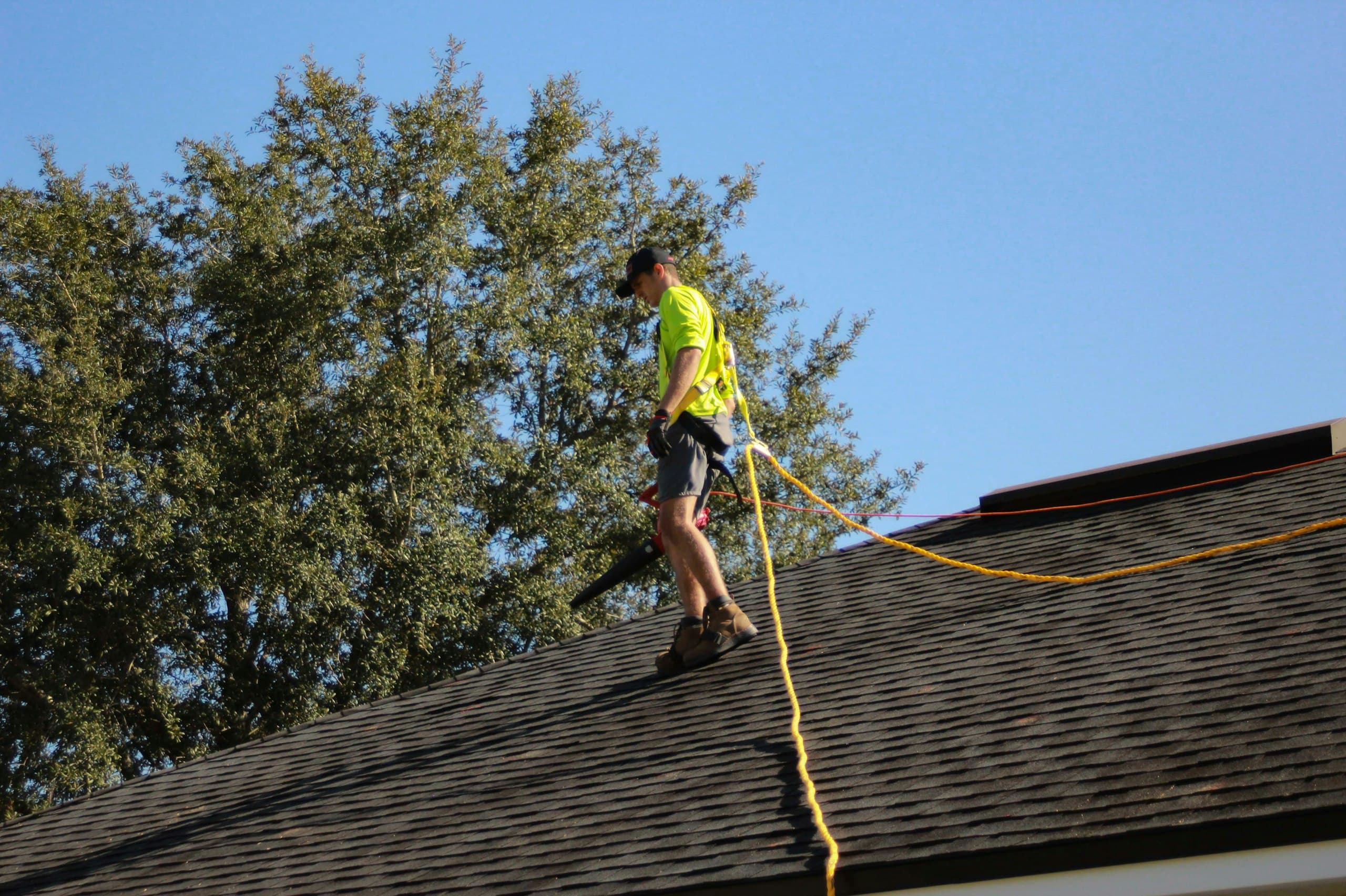 Inspector evaluating a residential roof during a home inspection
